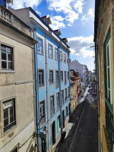 a blue building on the side of a street at House Rooms in Bairro Alto in Lisbon