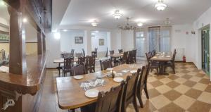 a large dining room with wooden tables and chairs at Świtezianka in Rymanów-Zdrój