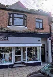 a store front of a brick building with windows at First floor Flat 1 Northwood in London