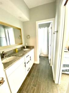 uma casa de banho com um lavatório e um espelho em Henderson Haven 4 BR / 3 BA Villa, Steps to Beach em Wrightsville Beach