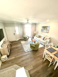 a living room with a couch and a table at Henderson Haven 4 BR / 3 BA Villa, Steps to Beach in Wrightsville Beach