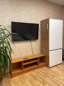 a living room with a tv and a white cabinet at Central Hostel Jelgava in Jelgava