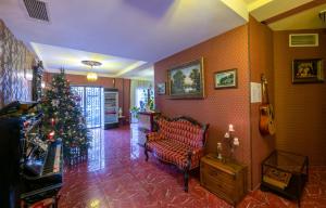 - Granada - Boutique Hotel - Tbilisi - في تبليسي: غرفة معيشة مع شجرة عيد الميلاد وأريكة