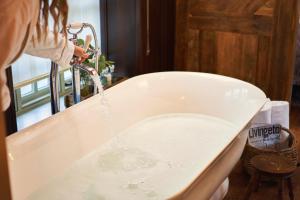 a person is drinking water from a faucet in a bath tub at The Masons Arms in Branscombe +38 photos