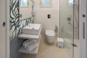a bathroom with a sink and a toilet and a shower at Brezza Marina in Lampedusa +16 photos