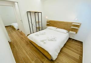 a bedroom with a bed with white sheets and a mirror at Villa Olimpo in Avola +64 photos