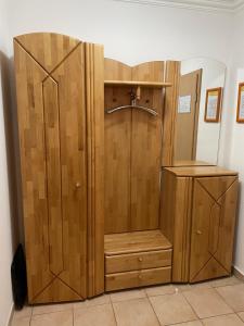 a shower with a wooden cabinet and a sink at Ferienwohnung Juliane in der Villa zum Kronprinzen direkt gegenüber der Saarow Therme in Bad Saarow