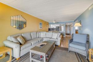 a living room with a couch and two chairs at Salty Sands in Ocean City