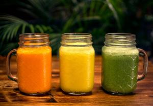 three mason jars filled with different types of juice at KACLLA, The Healing Dog Hostel in Lima