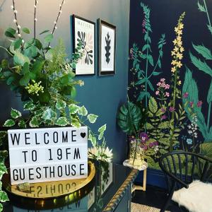 a welcome sign in a room with plants on the wall at Franklin Mount Boutique Guesthouse in Harrogate