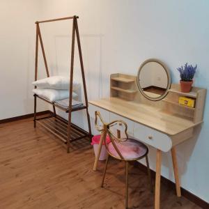 a dressing table with a mirror and a chair at Romance in de house 3-5pax Two Parking Free, There is a shopping mall downstairs in Kuala Lumpur