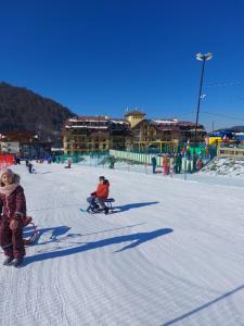 a group of people in the snow at a ski slope at Bakuriani Ski Apartment-Didveli Tulip A34 in Bakuriani