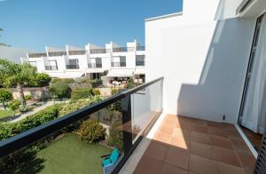 an apartment balcony with a view of a building at Casa Residencial Playa Fontanilla in Conil de la Frontera