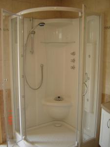 a shower stall in a bathroom with a toilet at De Kleen Meulen - max 6pers in Lummen