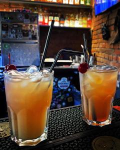 two cocktails sitting on a table in a bar at СЕЙФ: міні-готель 24х7 in Ivano-Frankivsʼk