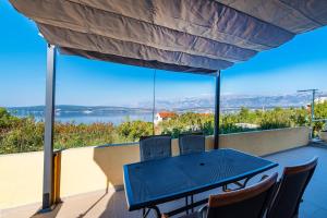 a blue table and chairs on a balcony with a view at Apartment Milena in Novigrad Dalmatia