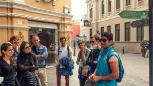 a group of people standing on a street corner at KACLLA, The Healing Dog Hostel in Lima