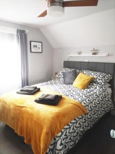 a bedroom with a bed with two towels on it at A Pebbles Throw - 300m from the beach. in Westward Ho