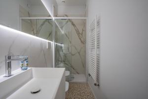 Ca' San Beneto Completely Refurbished in a fabulously central area في البندقية: حمام أبيض مع حوض ودش