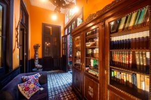 a living room with a book shelf filled with books at KACLLA, The Healing Dog Hostel in Lima
