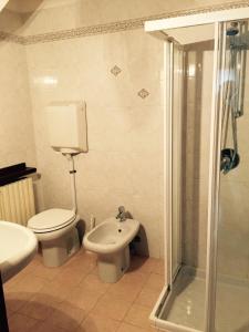 a bathroom with a toilet and a sink and a shower at Casa Valentina in Brenzone sul Garda
