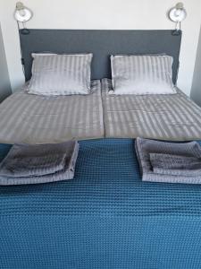 a bed with two pillows on top of it at Studio with balcony and a great sea view in Helsinki