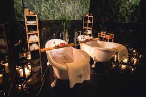 a bathroom with two sinks and a tub and lights at Bliżej Nieba in Skrzydlna