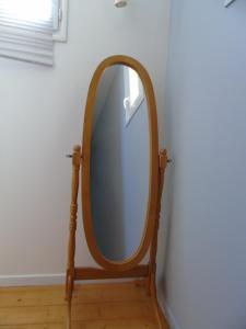a mirror on a wooden stand in a room at Chez Marie et Gégé in Puyréaux