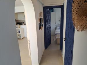 a hallway with a blue door leading to a bedroom at la ventana al mar in Jávea