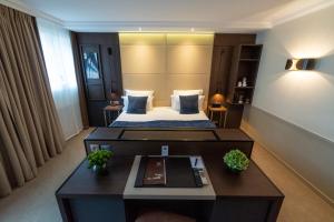 Rúm í herbergi á Hotel Villa Saxe Eiffel