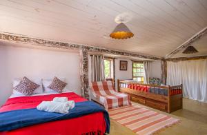 a bedroom with a large bed and a crib at Pousada Barulho D' água in Ilhabela