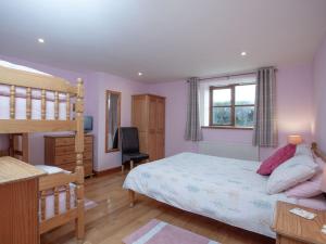 a bedroom with a bunk bed and a desk at The Old Mill House in Welcombe