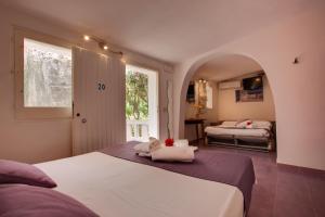 Cama ou camas em um quarto em L'Oasi Villaggio Albergo