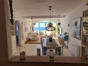a kitchen and dining room with a view of the ocean at la ventana al mar in Jávea