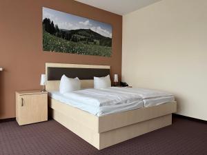 Postel nebo postele na pokoji v ubytování Hotel Am Heidepark + 26 fotografií