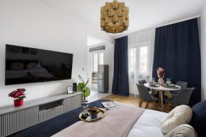 a living room with a large television on a wall at Apartments Old Town by Arrenda in Warsaw