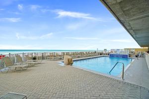 a swimming pool with a view of the ocean at Emerald Isle by Panhandle Getaways in Panama City Beach