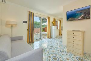 a living room with a couch and a dresser at Camping Village Scaglieri in Portoferraio