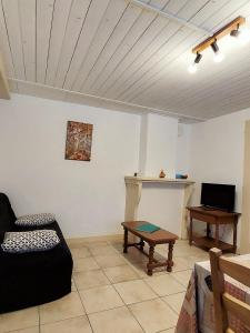 a living room with a couch and a table at Gite Les Loges d'Arbez in Septmoncel