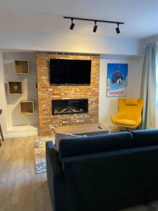ein Wohnzimmer mit einem Sofa und einem Kamin in der Unterkunft Bromont Lodge 871 Shefford suite 205 in Bromont