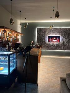 a bar with a fireplace in the middle of a room at Цахкадзор, Tsaxkadzor, Kechi House apartment 300 in Tsaghkadzor