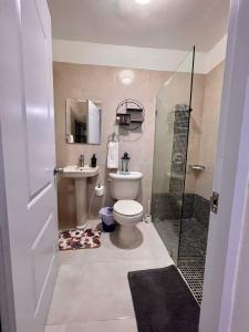 a bathroom with a toilet and a shower and a sink at Private Pool View 2BDR in Los Corales Punta Cana in Punta Cana