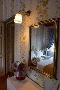 a bedroom with a bed with a mirror and a fan at Greece Seaside villa 200sq m 20m from sea in Káto Alepokhórion