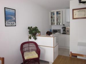 a kitchen with a counter and a chair in a room at Habitaciones López Azcona in Noja
