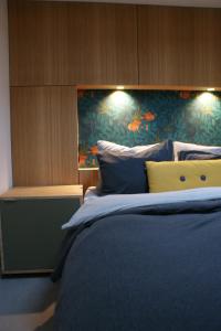 ein Schlafzimmer mit einem großen Bett mit blauer Bettwäsche in der Unterkunft Sommarhus in Zandvoort