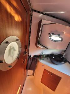 a bathroom with a sink and a mirror at River San yacht in Rajskie