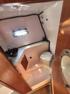 a small bathroom with a toilet and a sink at River San yacht in Rajskie