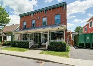 a red brick building with a store on a street at condo 3 chambres vue sur la montagne 837-202 in Bromont