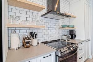 a kitchen with white subway tiles and a stove at condo 3 chambres vue sur la montagne 837-202 in Bromont