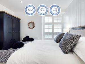a bedroom with a large bed with blue and white plates on the wall at Driftwood Boutique Guest House in Rhosneigr